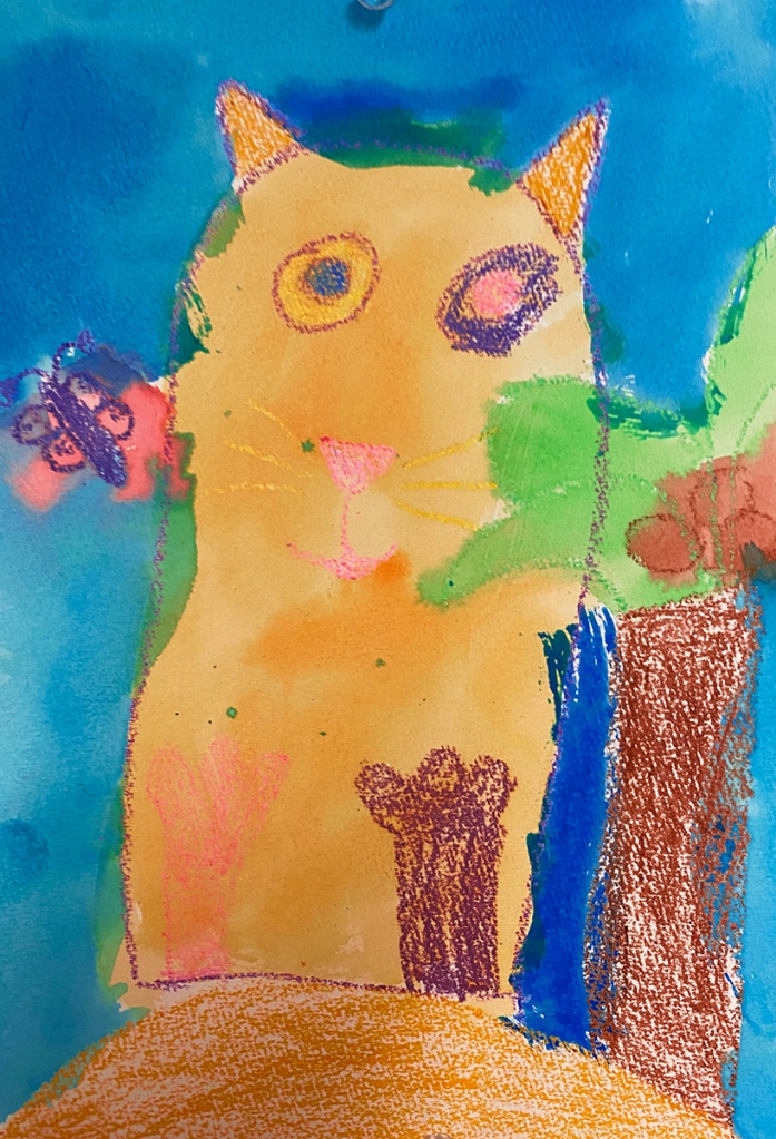 Kindergarten watercolor & crayon resist, finished composition. This shows a large-eyed orange cat next to a palm tree and butterfly, on a blue background.